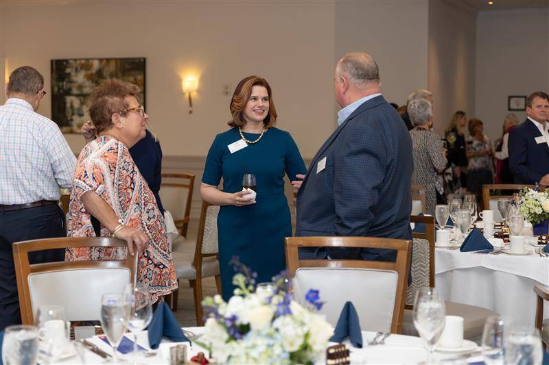 Foundation Director Laura Aikens talking with event guests